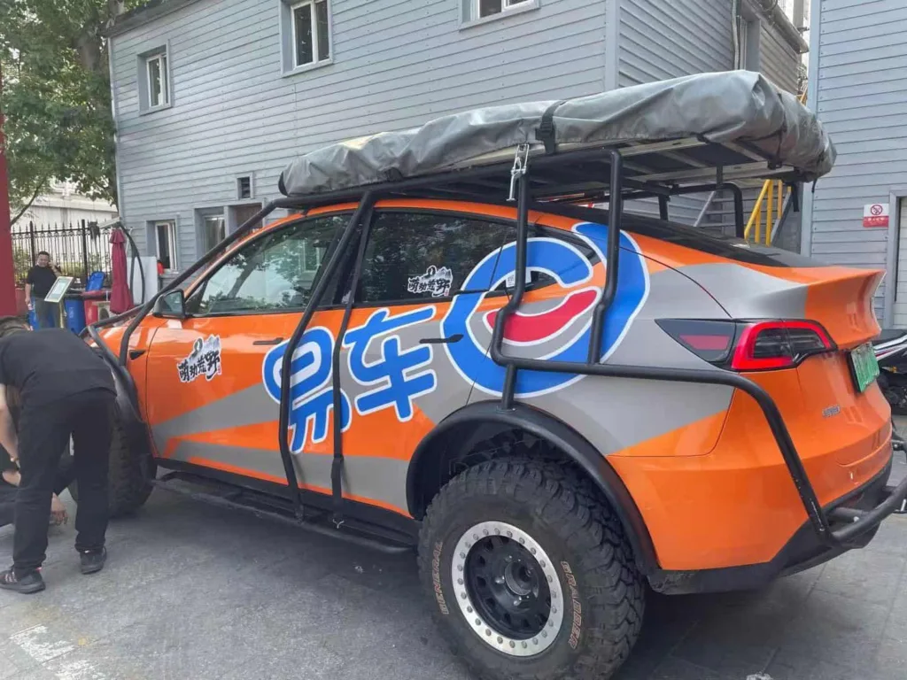Tesla Model Y covering orange