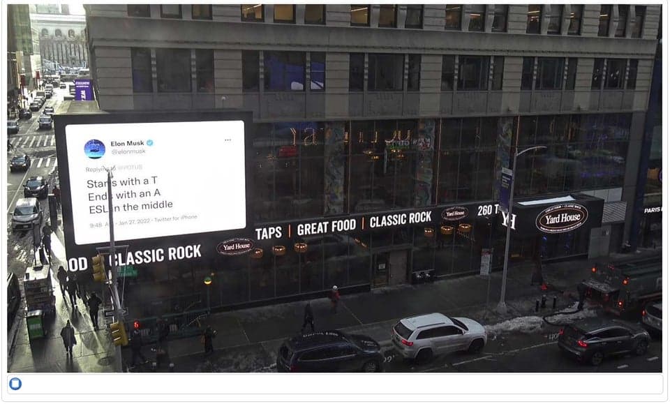 Photo de l'affichage, à New-York, d'un tweet d'Elon Musk aux propos de Biden et Barra concernant les investissements dans les VE