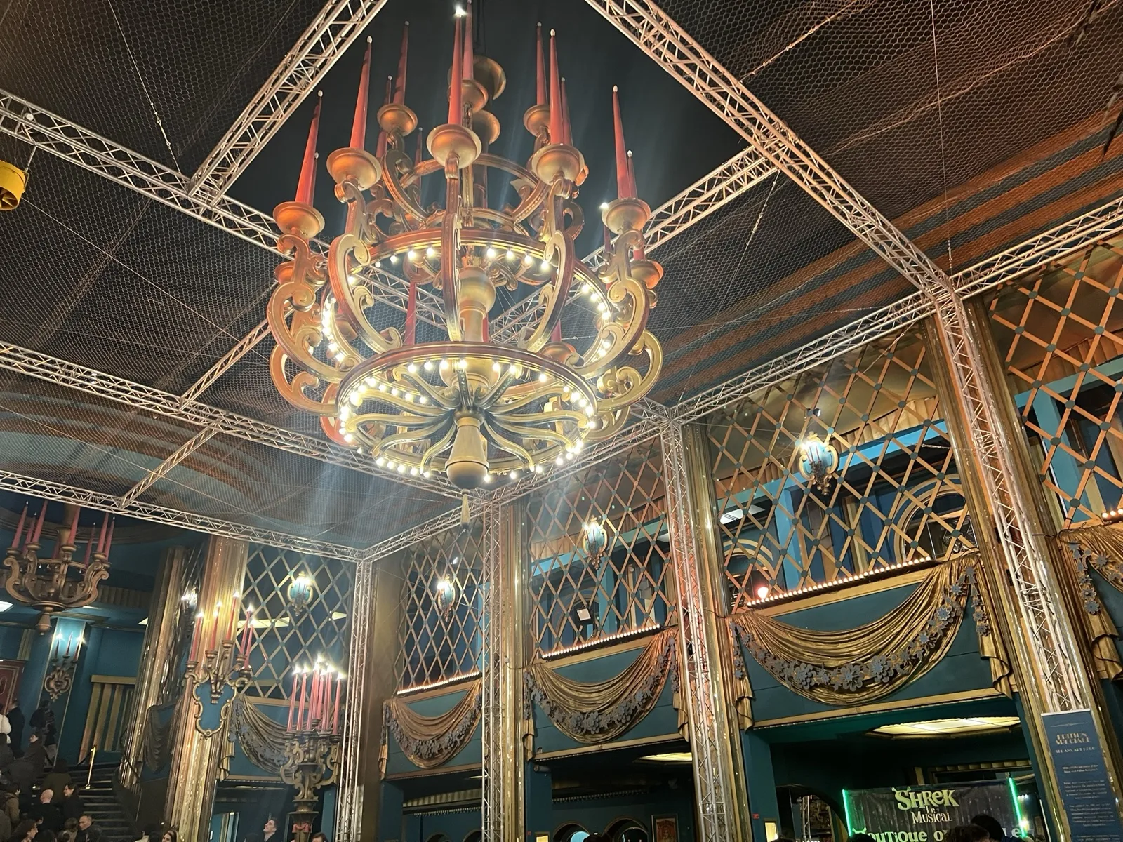 Le hall des Folies Bergère, son lustre et l'affiche de Shrek le Musical