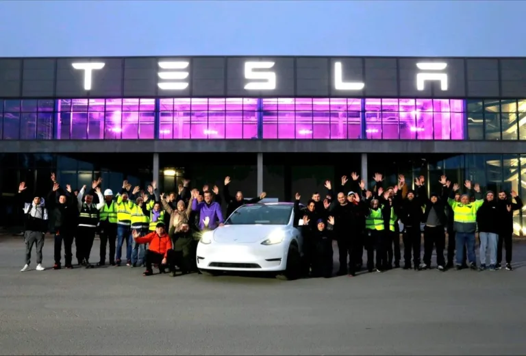 Tesla workers celebrating in front of the Giga Berlin factory