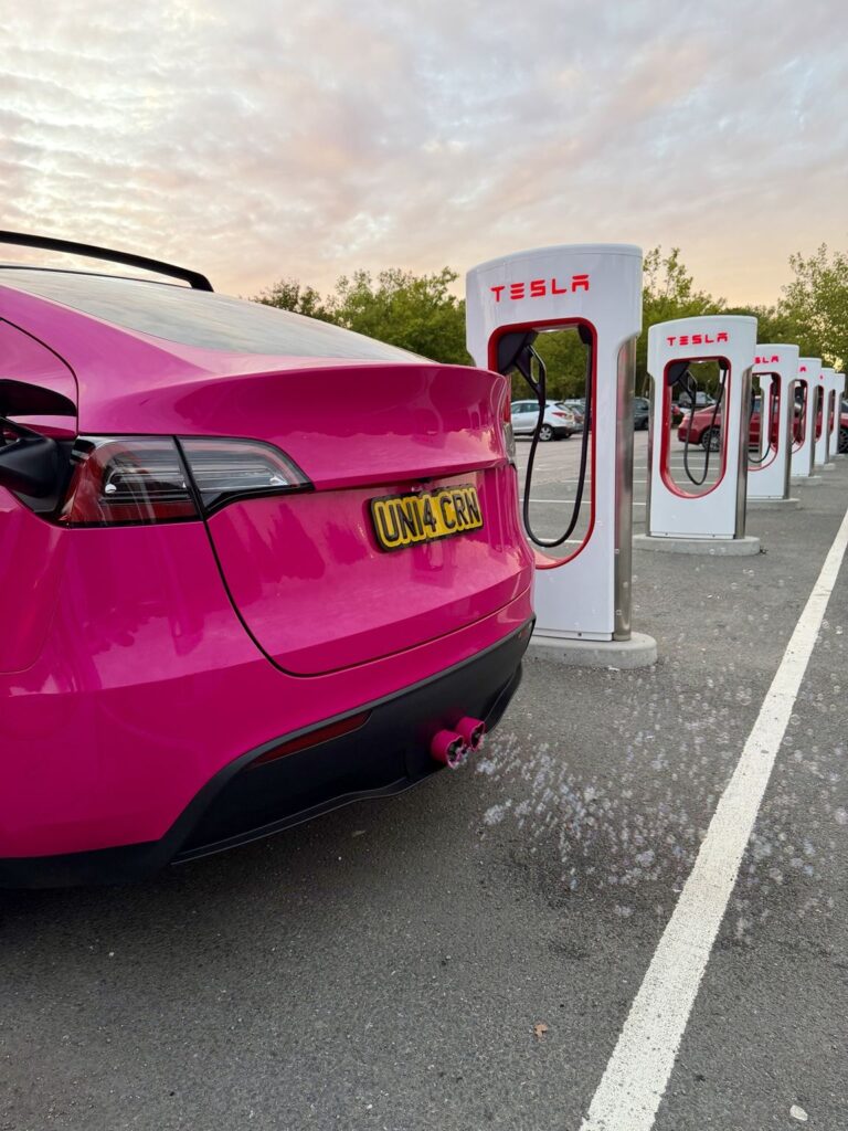 Bubbles coming out of the heart-shaped exhaust tips of The Unicorn Tesla at a Supercharger