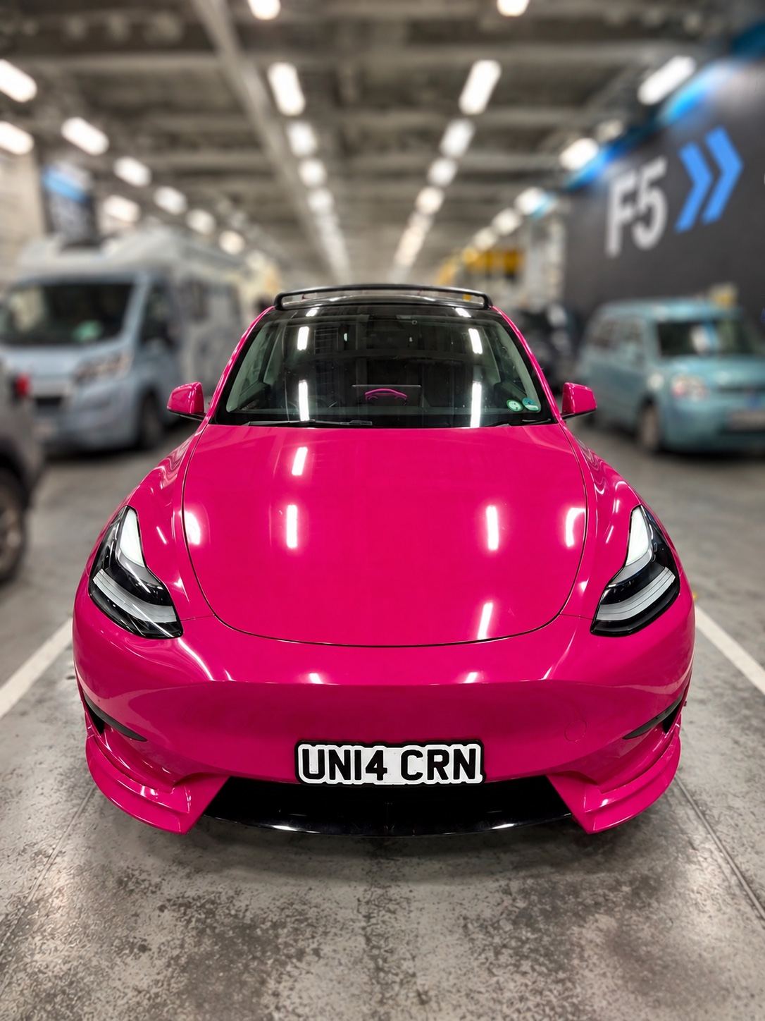 The Unicorn, a pink Tesla Model Y wrapped in KPMF Momentum Pink, UN14 CRN plate