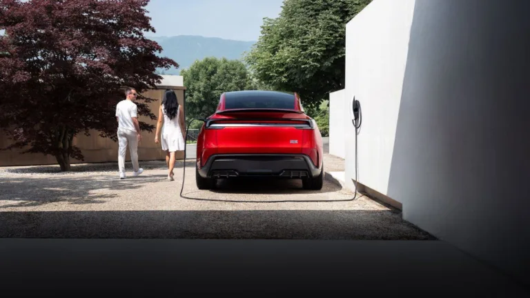 A Tesla Model Y charging at home on a Wall Connector